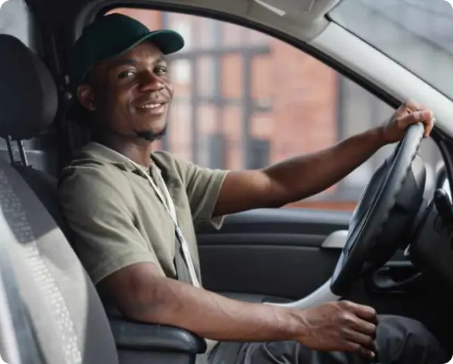 Smiling Driver sitting in vehicle